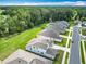 Aerial shot showing the arrangement of houses along a street near wooded areas, showcasing a green environment at 7067 Sw 60Th Ln, Ocala, FL 34474