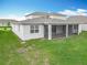 Exterior of home showing the backyard and screened lanai with grassy green lawn at 7067 Sw 60Th Ln, Ocala, FL 34474