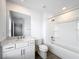 Modern bathroom with white vanity, large mirror, and shower/tub combo at 7067 Sw 60Th Ln, Ocala, FL 34474