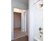 Bathroom with wood look flooring, white shower and open doorway at 7067 Sw 60Th Ln, Ocala, FL 34474