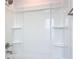 Bright, clean bathroom with tub and shower featuring built-in shelving at 7067 Sw 60Th Ln, Ocala, FL 34474