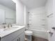 Bright bathroom features a shower-tub combo and a white vanity with a modern sink and countertop at 7067 Sw 60Th Ln, Ocala, FL 34474