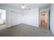 Neutral carpet bedroom with ceiling fan and double door closet at 7067 Sw 60Th Ln, Ocala, FL 34474