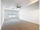 Bright bedroom featuring neutral carpet, a ceiling fan, recessed lighting, and a large window at 7067 Sw 60Th Ln, Ocala, FL 34474