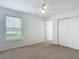 Bedroom with plush carpet, window, and closet with sliding doors at 7067 Sw 60Th Ln, Ocala, FL 34474