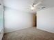 Bedroom boasts neutral carpet, window, and door to the rest of the house at 7067 Sw 60Th Ln, Ocala, FL 34474