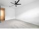 Bright bedroom with a modern ceiling fan, gray carpet, and white walls creating a clean space at 7067 Sw 60Th Ln, Ocala, FL 34474