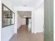 Bright entryway featuring tile flooring, neutral walls, and decorative mirrors with an open view to the living area at 7067 Sw 60Th Ln, Ocala, FL 34474
