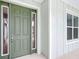 Exterior front door features sidelight window, and complementary siding, enhancing curb appeal at 7067 Sw 60Th Ln, Ocala, FL 34474