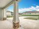 Close-up of a porch column shows detailed brickwork at the base, complemented by decorative white stones and a clear view at 7067 Sw 60Th Ln, Ocala, FL 34474