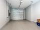 Spacious garage features a speckled floor, overhead door, and ample room for vehicles and storage at 7067 Sw 60Th Ln, Ocala, FL 34474