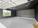 Spacious garage features a window and a speckled floor, providing ample room for vehicles and storage at 7067 Sw 60Th Ln, Ocala, FL 34474