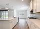 Well-appointed kitchen showcasing a large island, stainless steel appliances, and seamless flow to the living area at 7067 Sw 60Th Ln, Ocala, FL 34474