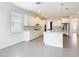 Bright, open kitchen with white cabinetry, island, stainless appliances, and tile flooring at 7067 Sw 60Th Ln, Ocala, FL 34474
