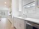 Modern kitchen with white cabinets, marble countertops, stainless steel appliances, and ample natural light at 7067 Sw 60Th Ln, Ocala, FL 34474
