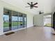 Relaxing screened lanai with ceiling fans and an open view to the backyard at 7067 Sw 60Th Ln, Ocala, FL 34474
