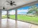 Relaxing screened lanai with ceiling fans and an open view to the grassy field beyond at 7067 Sw 60Th Ln, Ocala, FL 34474