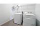 Functional laundry room with a washer, dryer, and wire shelving for storage and organization at 7067 Sw 60Th Ln, Ocala, FL 34474