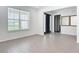 Open living room with tile floors, large windows with blinds, and a view of the front entryway at 7067 Sw 60Th Ln, Ocala, FL 34474