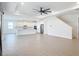 Expansive open-concept living space featuring tile floors, modern lighting, and a kitchen with white cabinetry at 7067 Sw 60Th Ln, Ocala, FL 34474