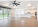 Spacious living area with an open floor plan, tile flooring, a modern fan, and access to the kitchen at 7067 Sw 60Th Ln, Ocala, FL 34474