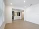 Bright, open living room with tile flooring and neutral walls, showcasing recessed lighting and entryway access at 7067 Sw 60Th Ln, Ocala, FL 34474