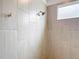 Walk-in shower with gray tiling and a shower head at 7067 Sw 60Th Ln, Ocala, FL 34474