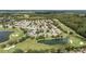 Breathtaking aerial shot of the residential community, complete with golf course, ponds, and lush greenery at 7243 Se 172Nd Legacy Ln, The Villages, FL 32162