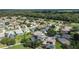 Picturesque aerial shot showcases a beautiful residential community with golf course and lush landscaping at 7243 Se 172Nd Legacy Ln, The Villages, FL 32162
