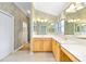Bright bathroom with dual vanities, tiled floors, and ample lighting at 7243 Se 172Nd Legacy Ln, The Villages, FL 32162