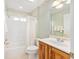 Cozy bathroom featuring white fixtures, wood vanity, a single sink, and tile floors at 7243 Se 172Nd Legacy Ln, The Villages, FL 32162