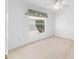 Neutral carpeted bedroom featuring a ceiling fan and natural light at 7243 Se 172Nd Legacy Ln, The Villages, FL 32162