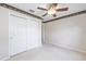 Bedroom with neutral carpeting and walls, white closet doors, and ceiling fan at 7243 Se 172Nd Legacy Ln, The Villages, FL 32162