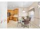 Breakfast nook featuring a round table, large windows, and an adjacent kitchen with stainless steel appliances at 7243 Se 172Nd Legacy Ln, The Villages, FL 32162