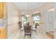 Charming breakfast nook featuring a round table and large windows, ideal for enjoying morning meals and natural light at 7243 Se 172Nd Legacy Ln, The Villages, FL 32162