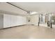 Spacious garage with epoxy flooring, cabinets and water heater at 7243 Se 172Nd Legacy Ln, The Villages, FL 32162