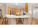 Bright kitchen includes stainless steel appliances, a wraparound breakfast bar, and an eat-in area by the front door at 7243 Se 172Nd Legacy Ln, The Villages, FL 32162