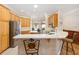 Inviting eat-in kitchen with stainless steel appliances, breakfast bar, and ample cabinet space for storage at 7243 Se 172Nd Legacy Ln, The Villages, FL 32162