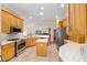 Spacious kitchen with stainless steel appliances, center island, bright lighting, and ample cabinetry space at 7243 Se 172Nd Legacy Ln, The Villages, FL 32162