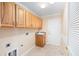 Functional laundry room with ample cabinet storage space and a utility sink at 7243 Se 172Nd Legacy Ln, The Villages, FL 32162
