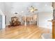 Open-concept living room with bamboo flooring, fireplace, and seamless access to the dining area and updated kitchen at 7243 Se 172Nd Legacy Ln, The Villages, FL 32162