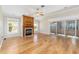 Spacious living room featuring a fireplace, wood floors, and sliding glass doors to lanai at 7243 Se 172Nd Legacy Ln, The Villages, FL 32162