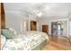 Bright main bedroom with a bed, wood floors and a view into the lanai at 7243 Se 172Nd Legacy Ln, The Villages, FL 32162