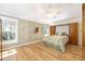 Bright main bedroom boasting wood floors, built in storage and a ceiling fan at 7243 Se 172Nd Legacy Ln, The Villages, FL 32162