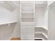 Spacious walk-in closet with built-in shelving and drawers for maximum organization at 7243 Se 172Nd Legacy Ln, The Villages, FL 32162
