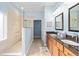 This bathroom features double sinks with granite countertops, a sleek glass-enclosed shower, and stylish tile flooring at 7454 Sw 101St Ave, Ocala, FL 34481