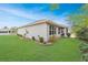 Lawn view of the house, showing the side yard, landscaping and screened patio at 7454 Sw 101St Ave, Ocala, FL 34481