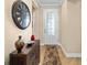Foyer with wood floors, cabinet with decorative accents, and a wall clock at 7454 Sw 101St Ave, Ocala, FL 34481