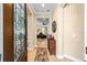 Inviting foyer with wood floors, a decorative rug, and a view into the living room at 7454 Sw 101St Ave, Ocala, FL 34481