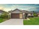 Charming single-story home with a well-manicured lawn, stone accents, and a two-car garage at 7454 Sw 101St Ave, Ocala, FL 34481